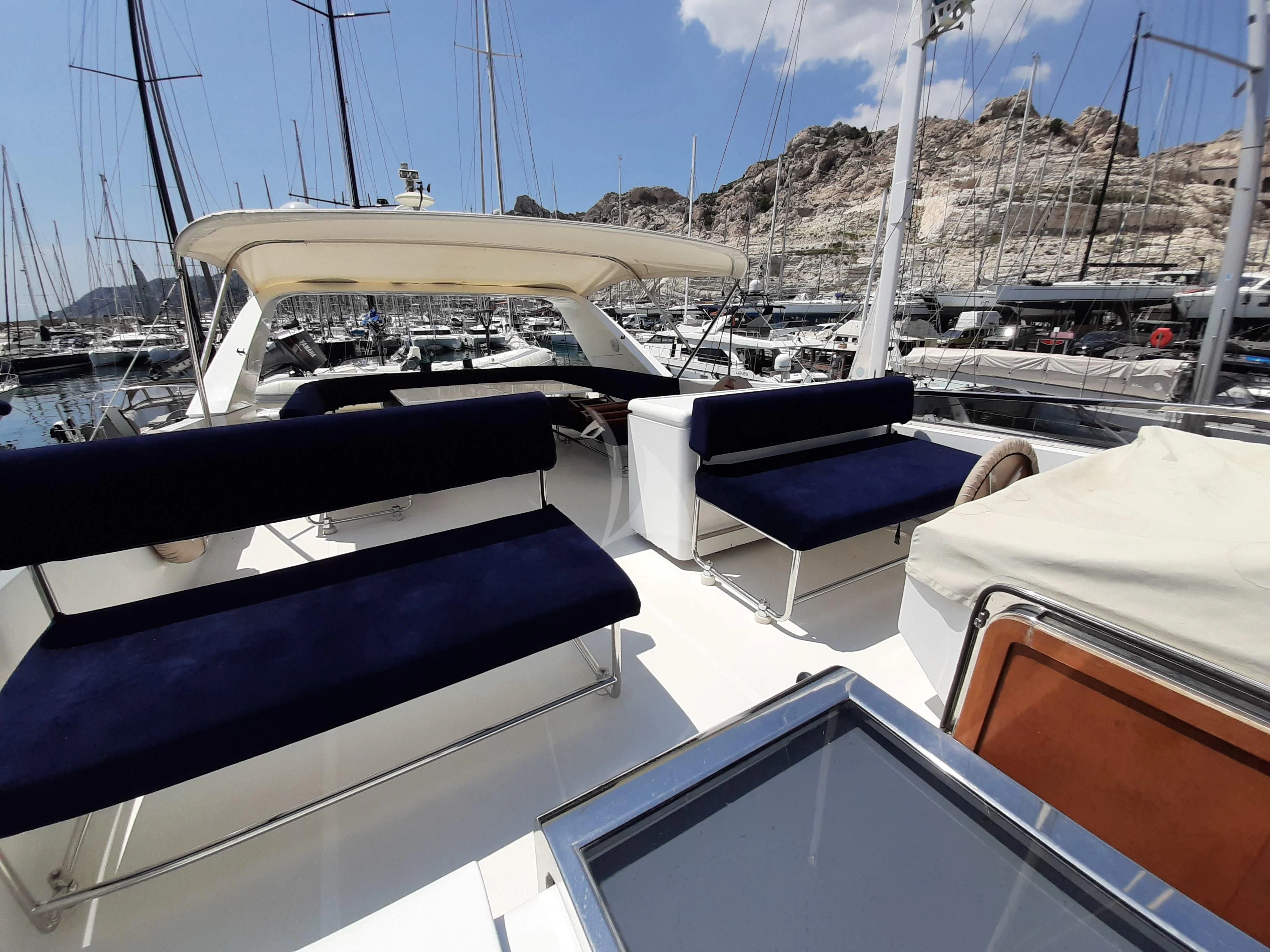 a boat with many seats aboard OLA Yacht for Charter