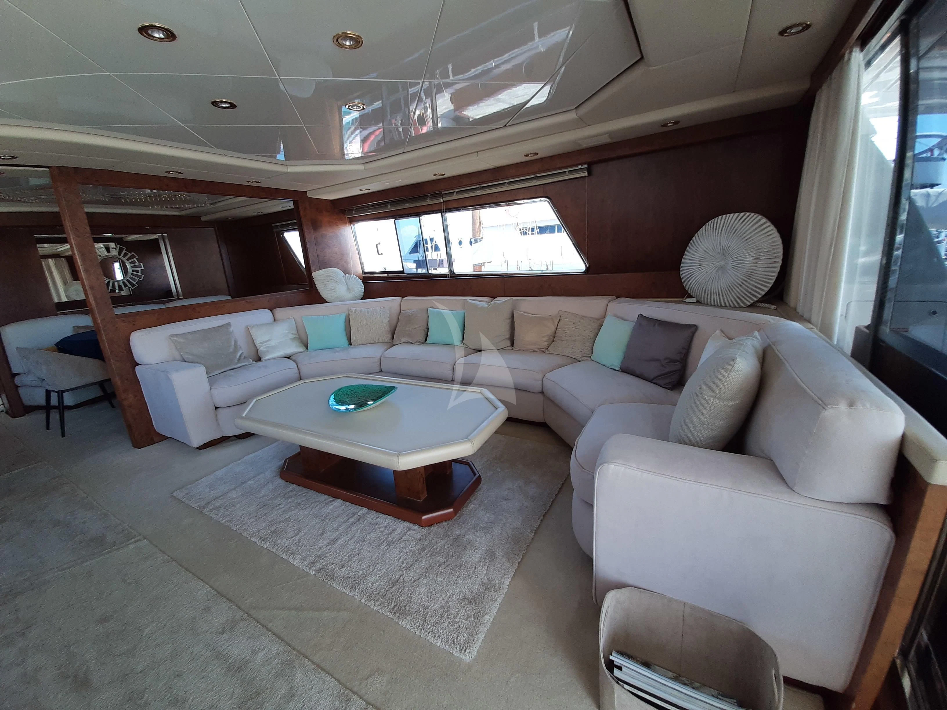 a living room with a couch and a table aboard OLA Yacht for Charter