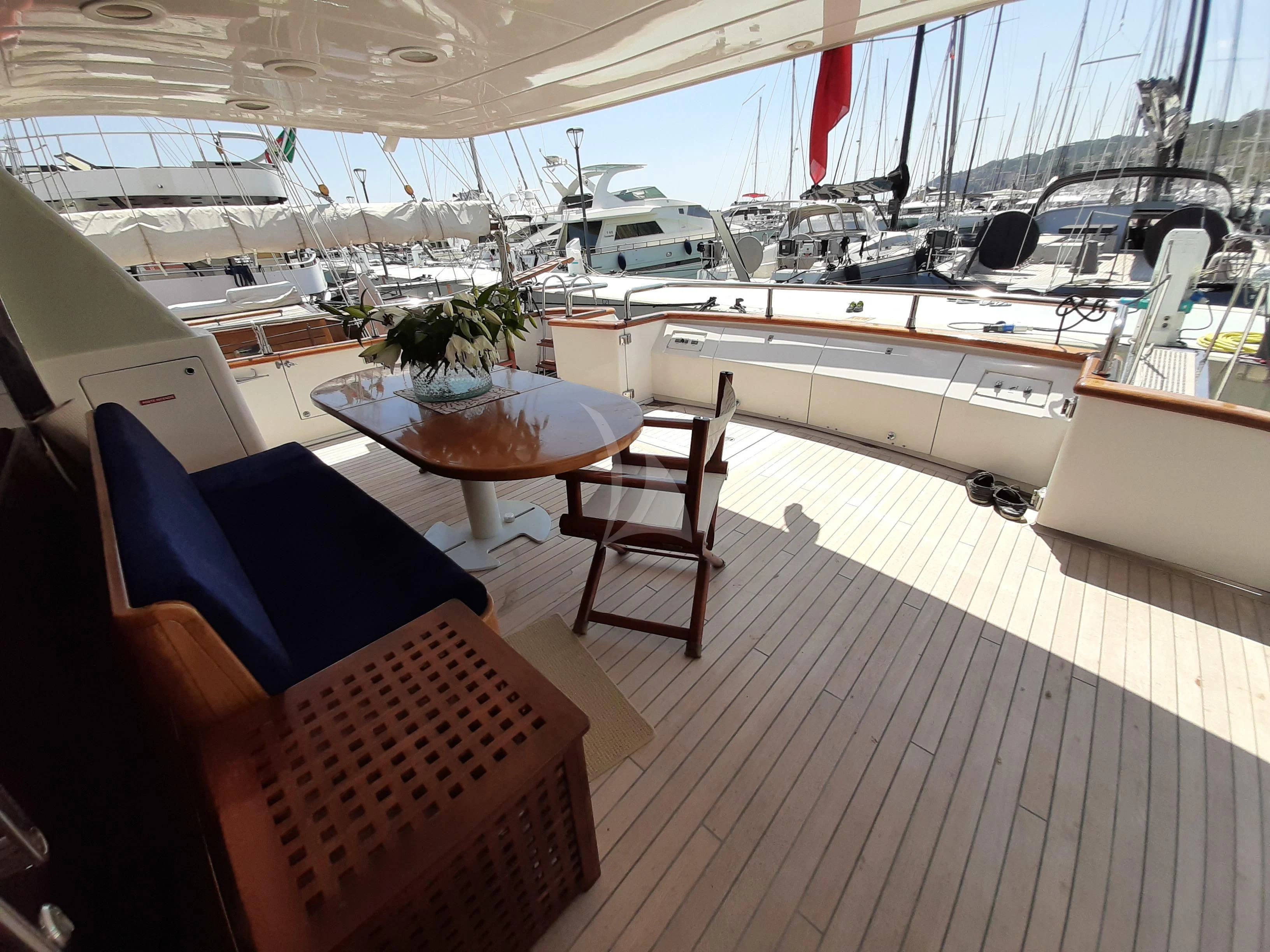 a boat with a table and chairs aboard OLA Yacht for Charter