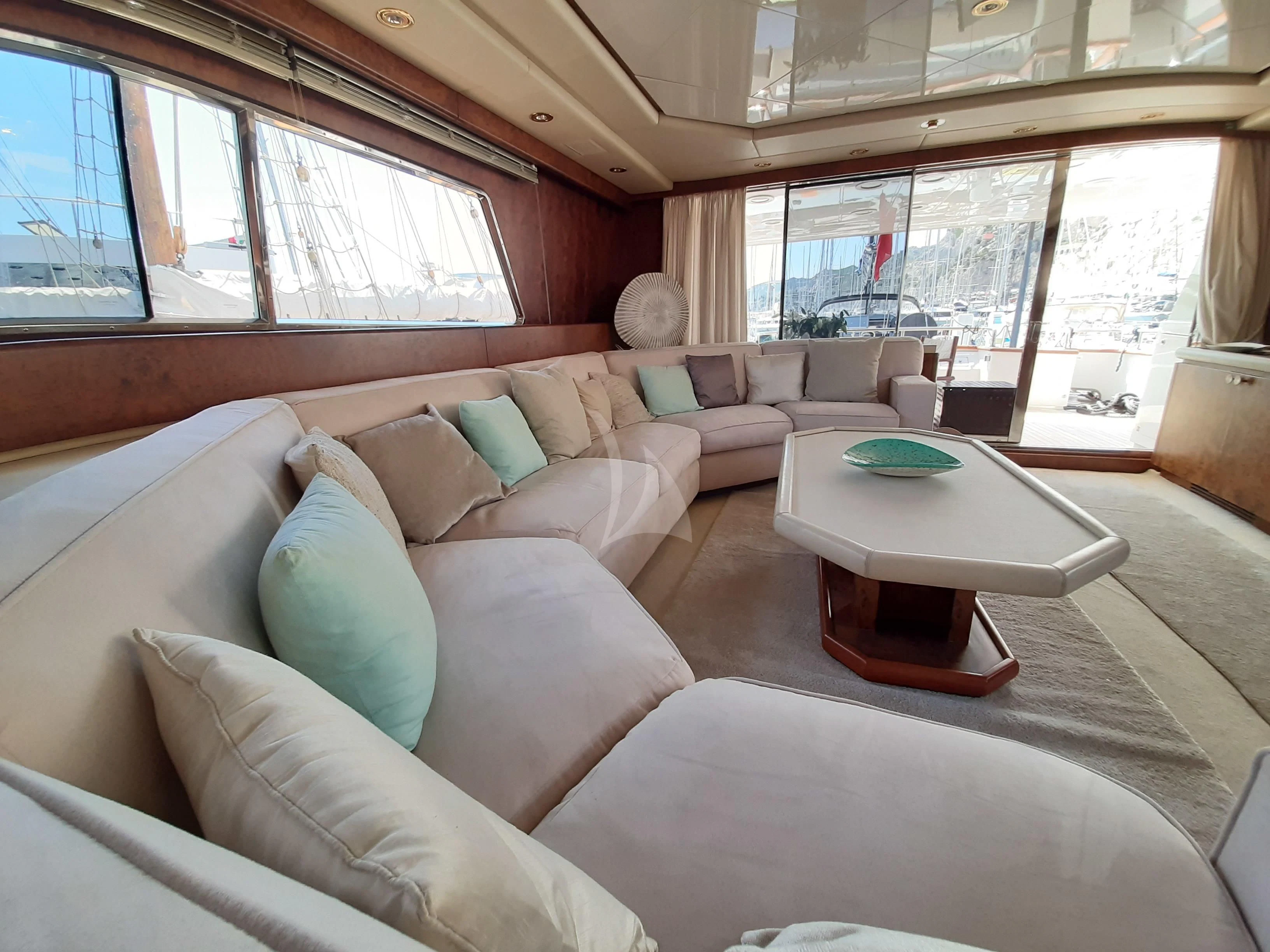 a living room with a couch and a table aboard OLA Yacht for Charter