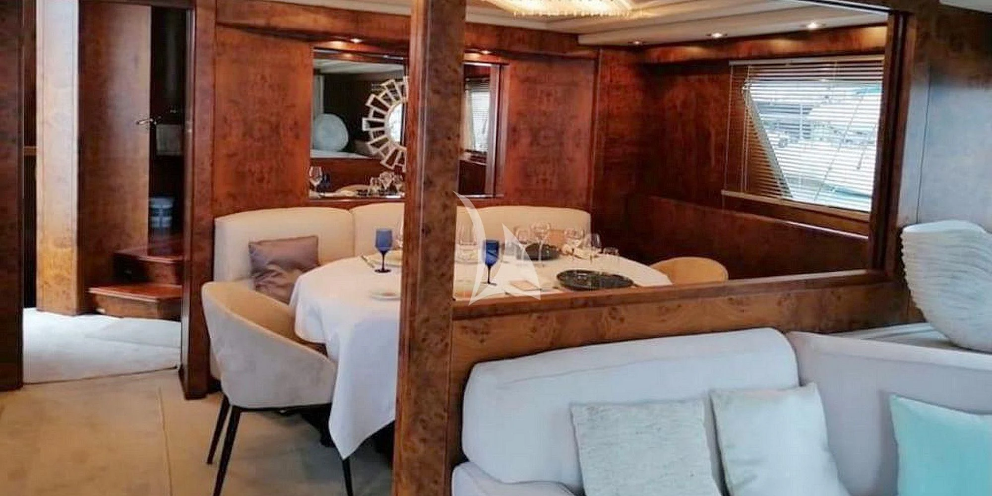 a room with a bed and a chair aboard OLA Yacht for Charter