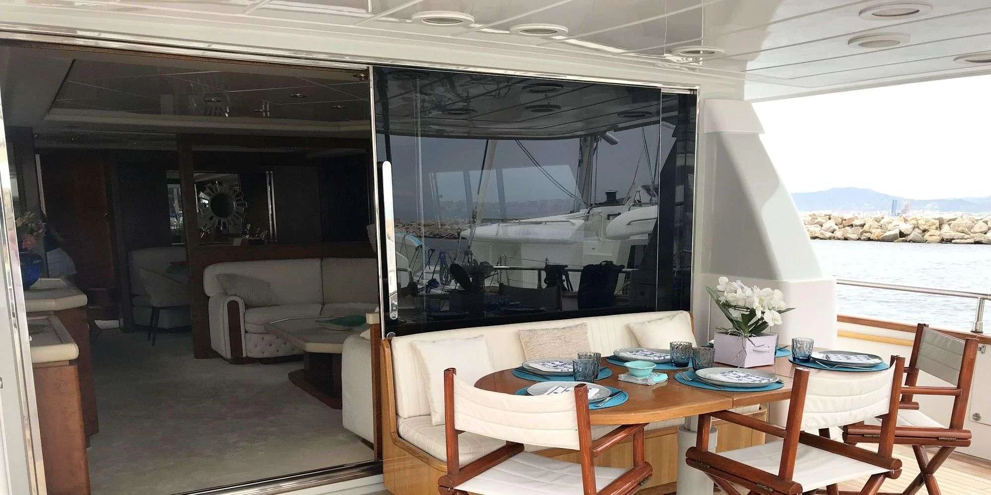 a room with a table and chairs aboard OLA Yacht for Charter