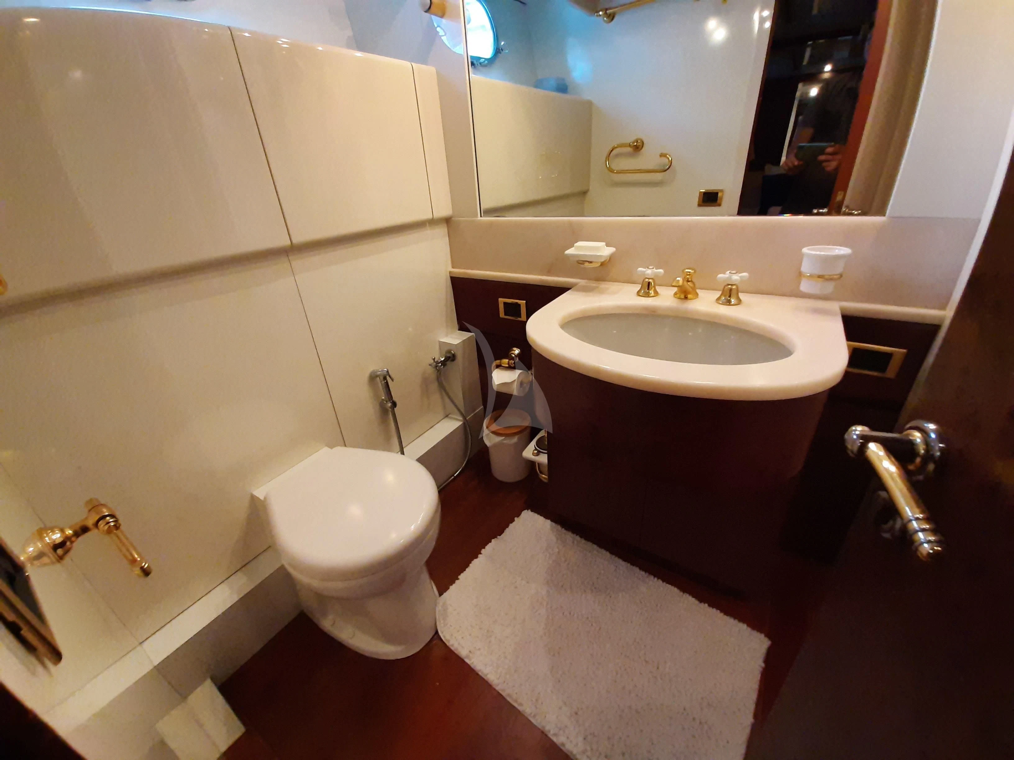 a bathroom with a sink and toilet aboard OLA Yacht for Charter