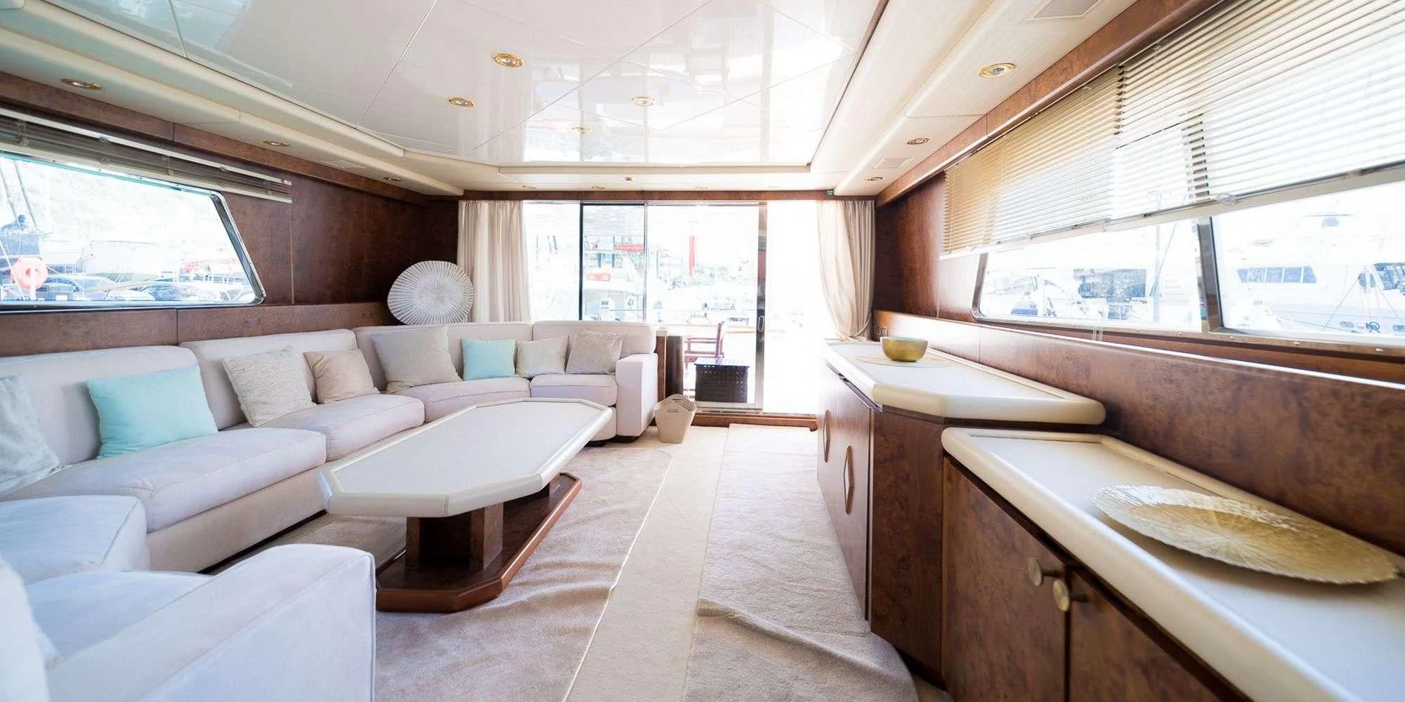 a large room with a couch and a table aboard OLA Yacht for Charter
