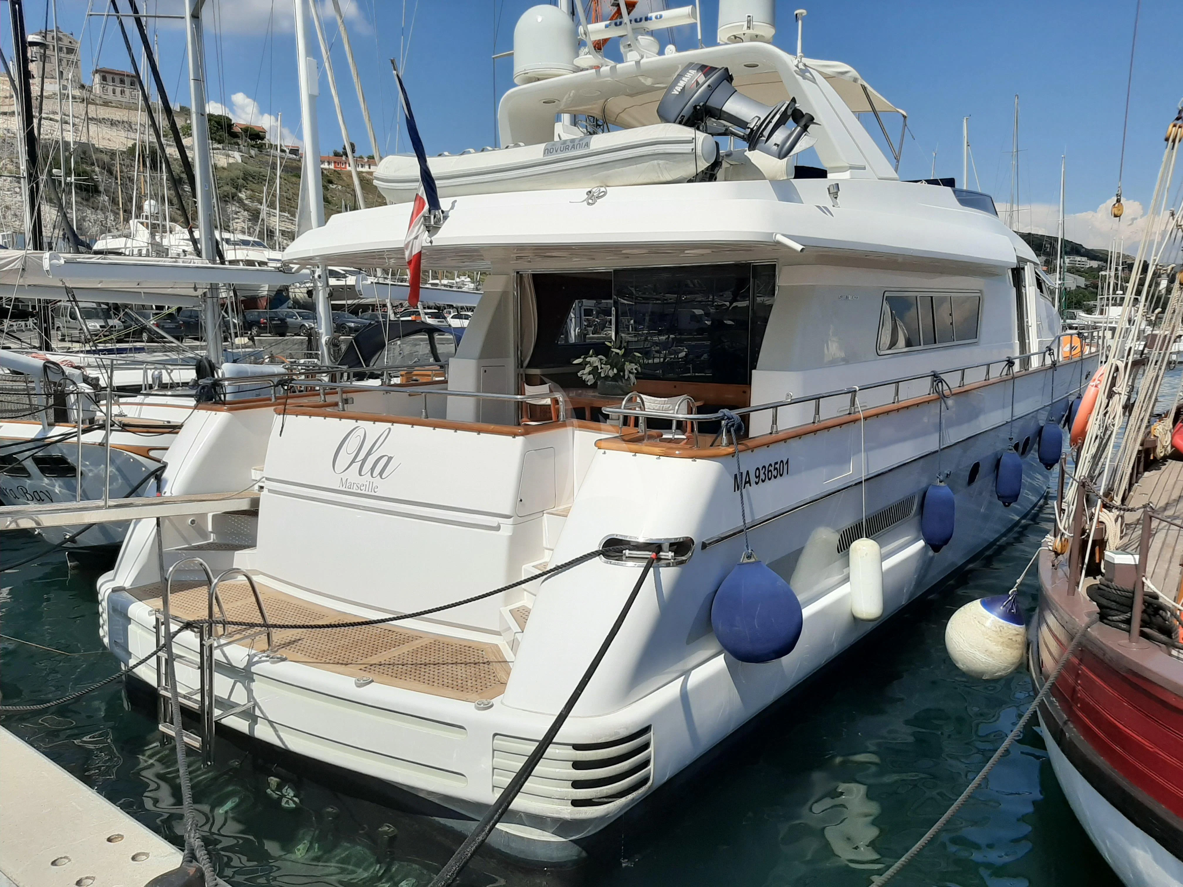 a boat docked at a pier aboard OLA Yacht for Charter