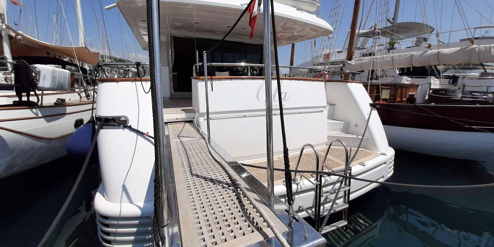 a group of boats are parked in a harbor aboard OLA Yacht for Charter