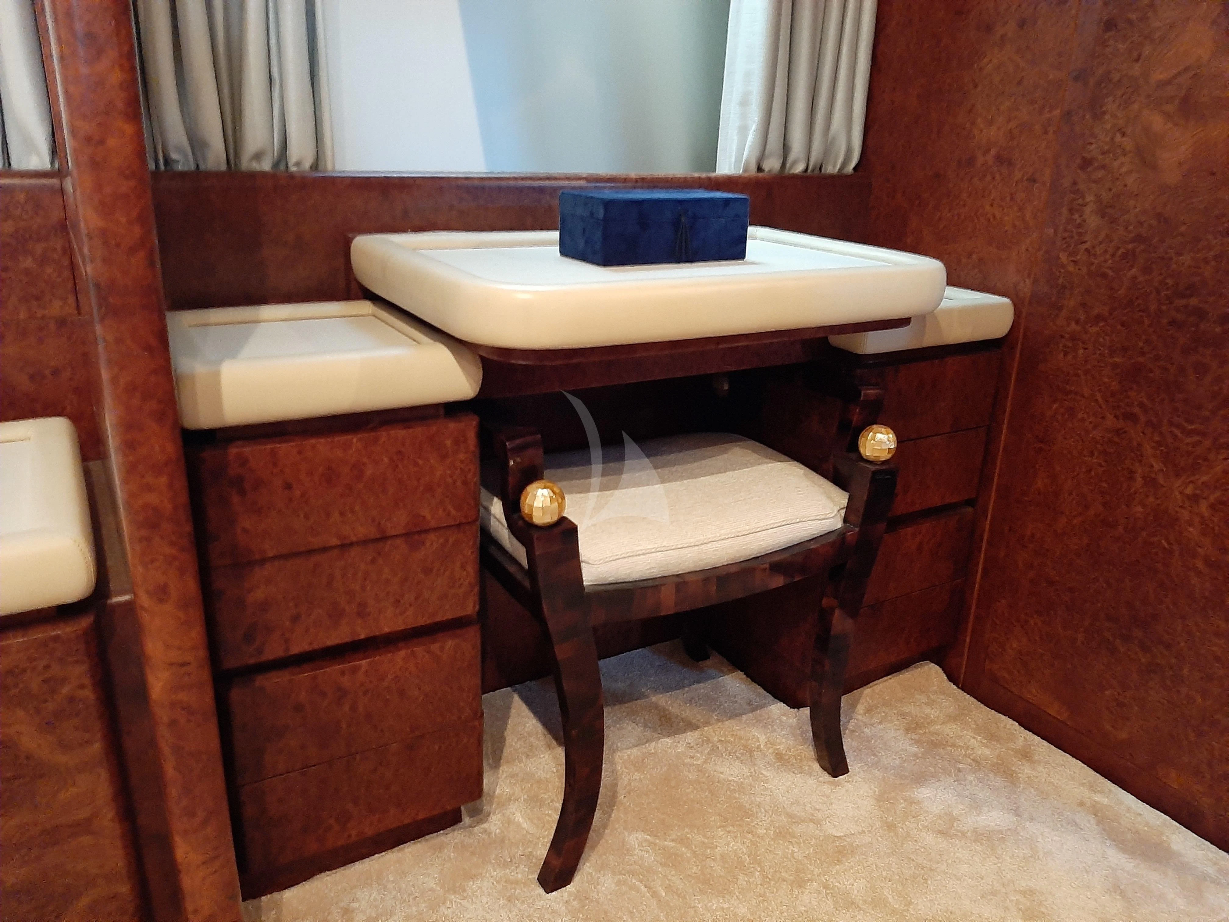 a desk with a chair and a table aboard OLA Yacht for Charter