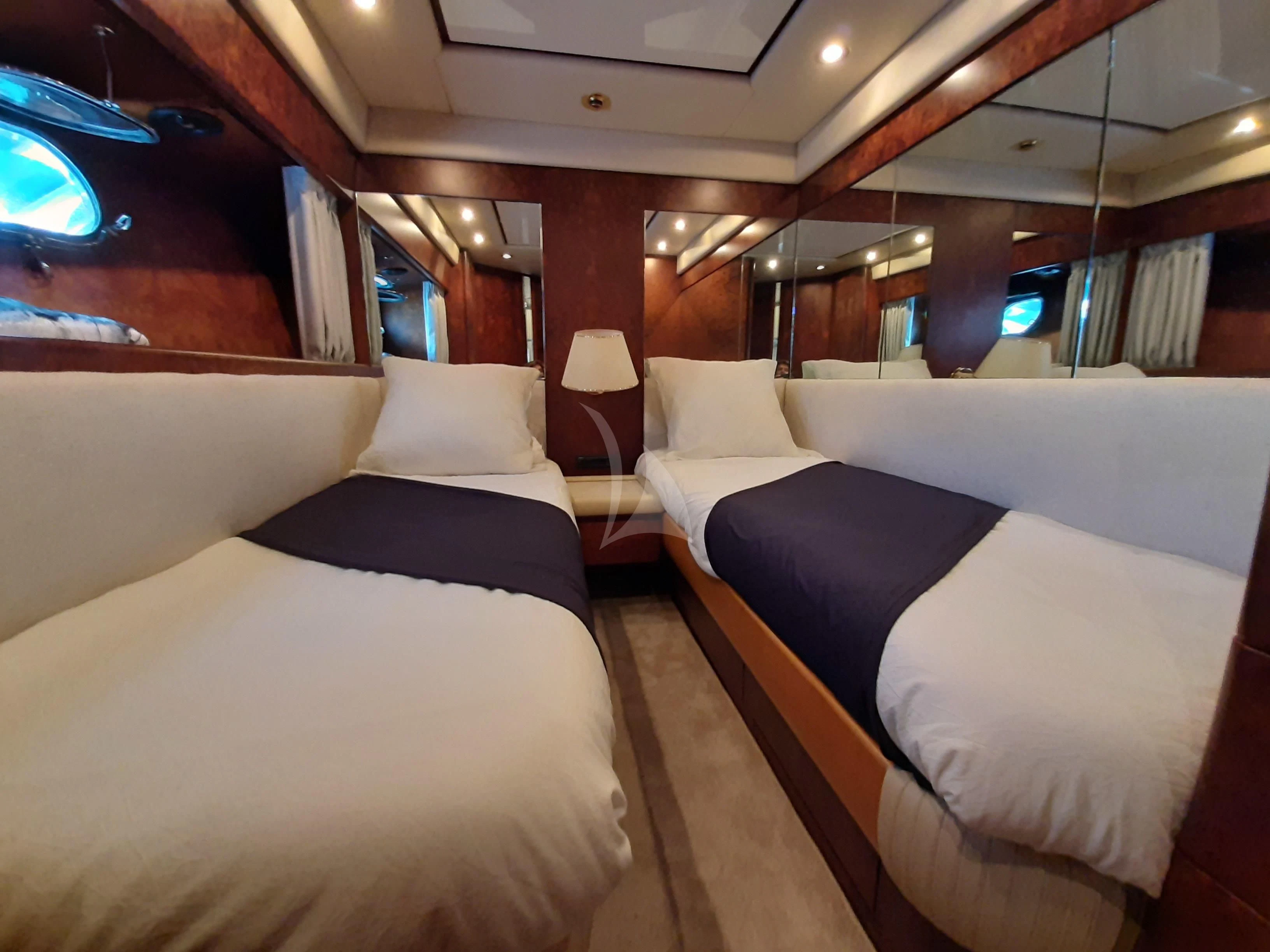 a room with beds and a window aboard OLA Yacht for Charter