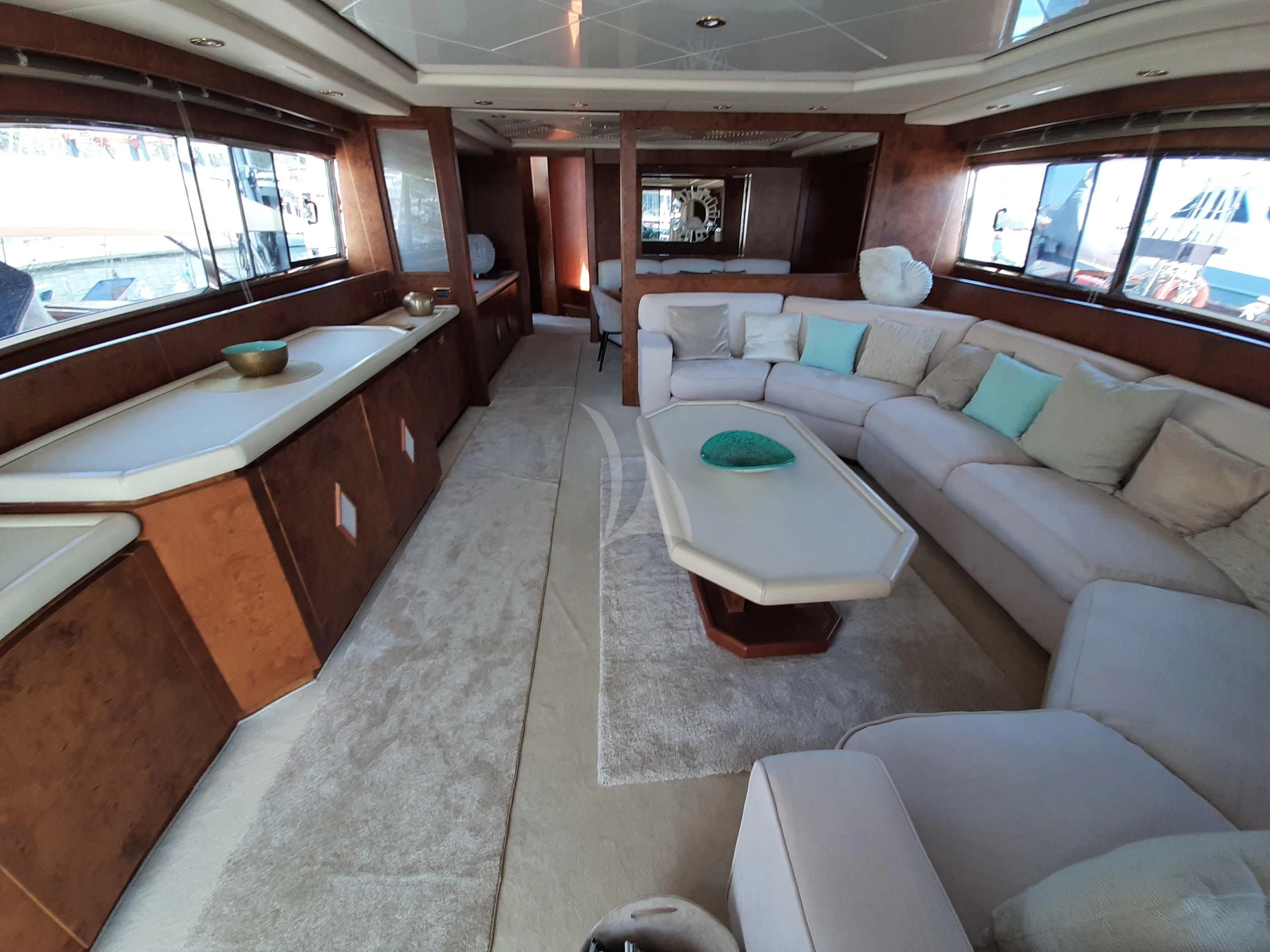 a living room with a couch and a table aboard OLA Yacht for Charter