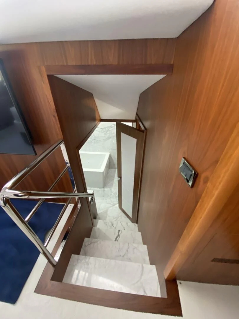 a wooden staircase with a glass door aboard SEAHORSE Yacht for Sale