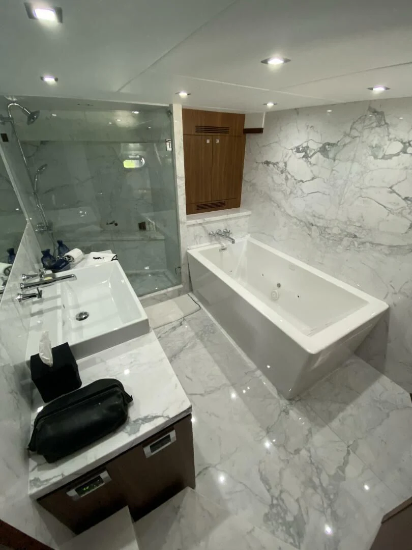 a bathroom with a tub sink and a mirror aboard SEAHORSE Yacht for Sale