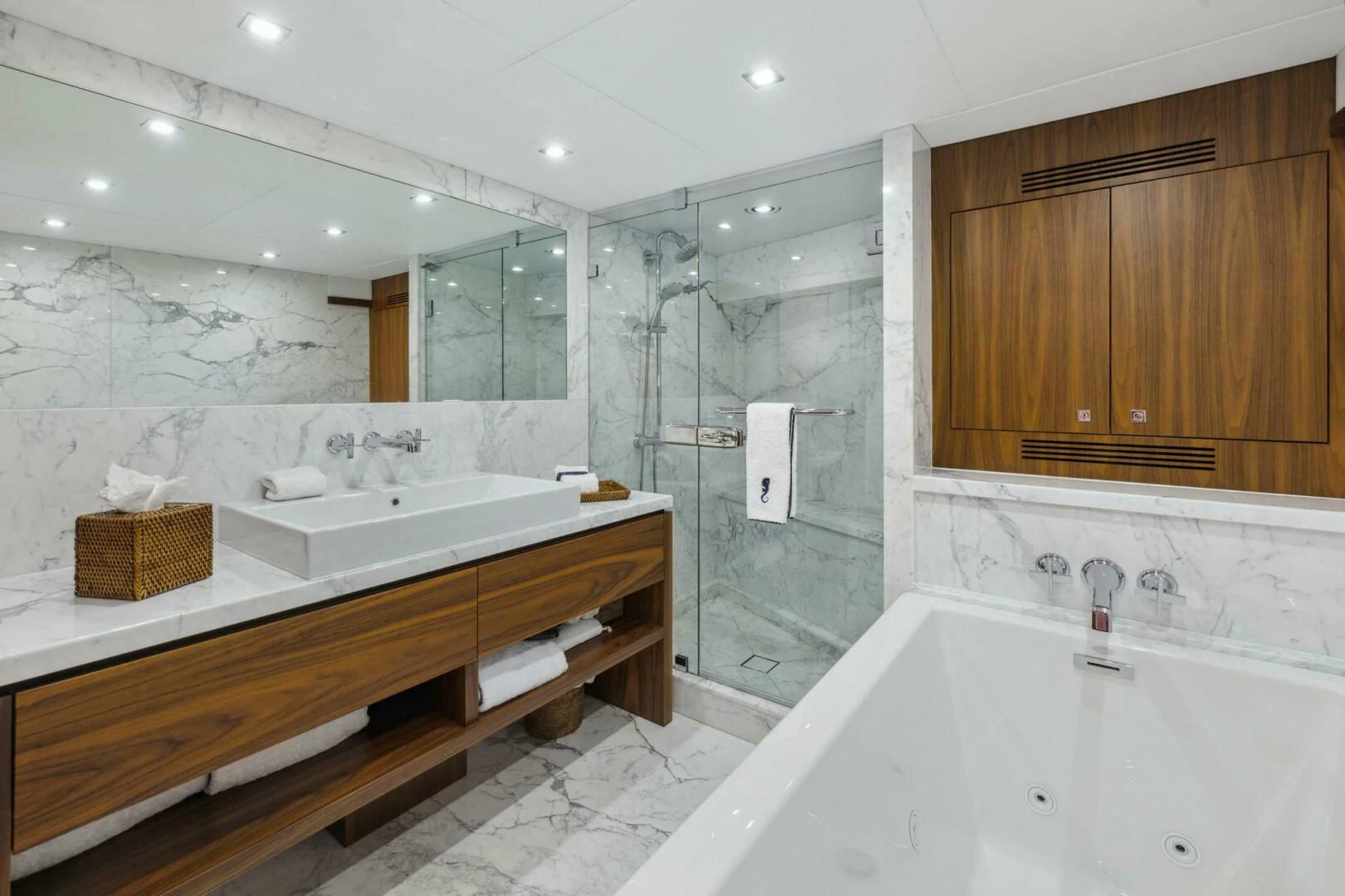 a bathroom with a bathtub and sinks aboard SEAHORSE Yacht for Sale