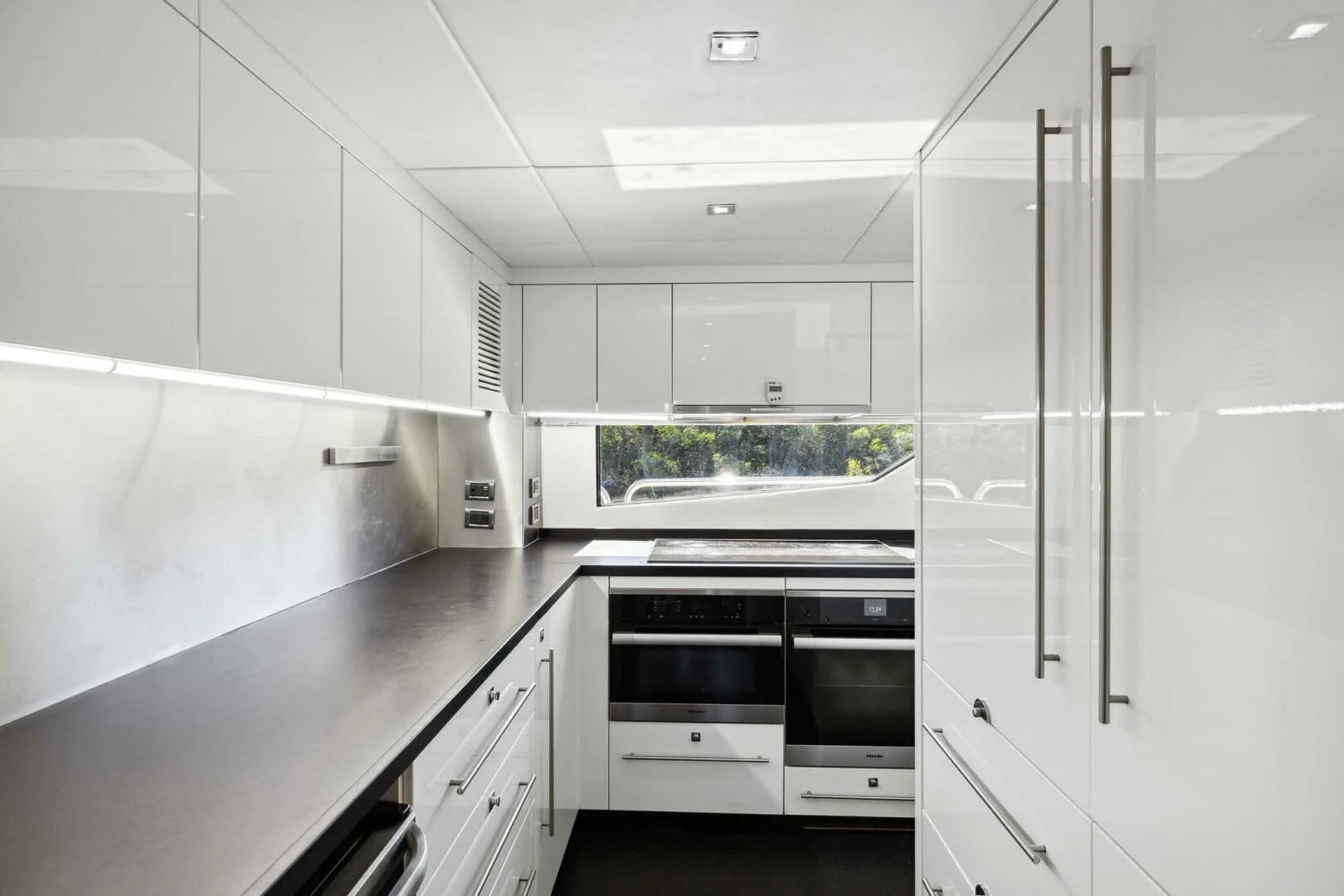 a kitchen with white cabinets aboard SEAHORSE Yacht for Sale