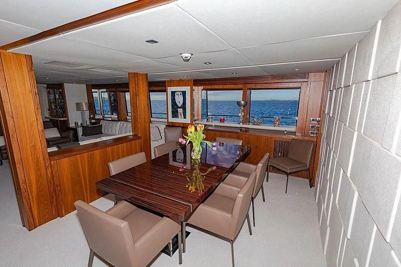 a room with a table chairs and a bench aboard SEAHORSE Yacht for Sale