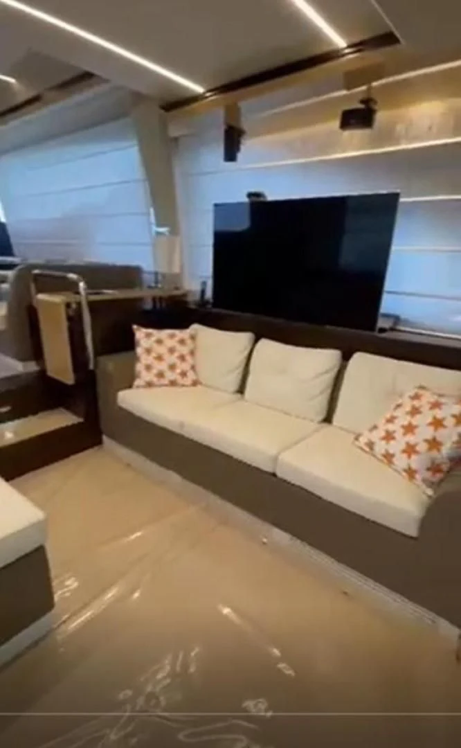 a room with a couch and a tv aboard PRIVE Yacht for Sale