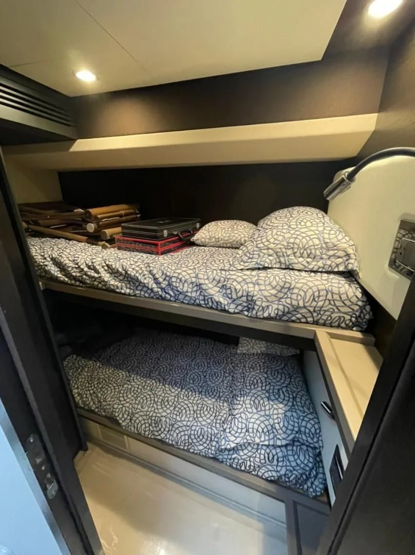 a bed with a couple of beds aboard PRIVE Yacht for Sale