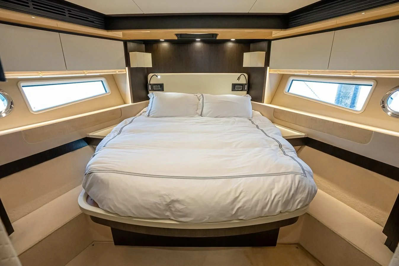 a room with a bed and a window aboard PRIVE Yacht for Sale