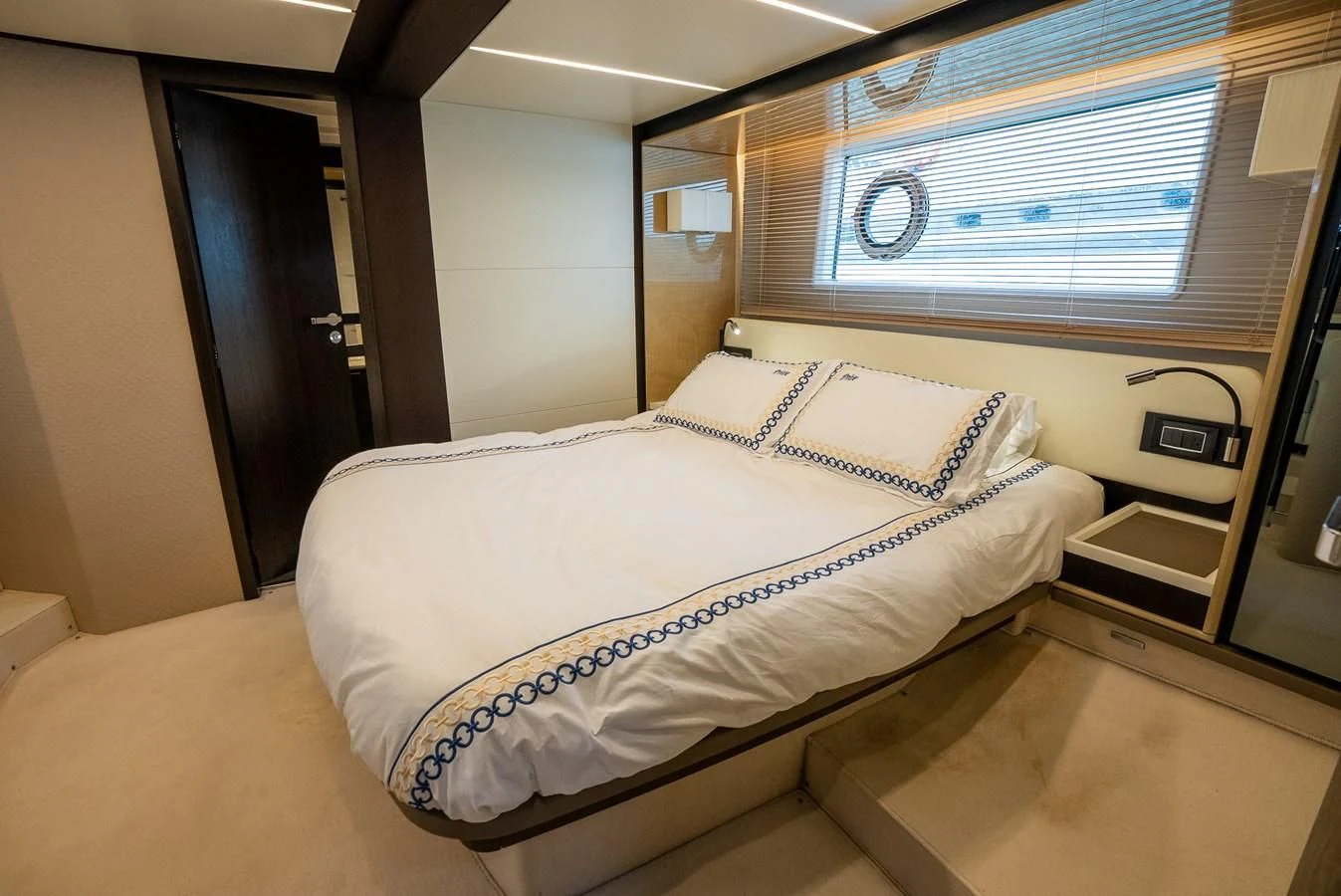 a bed with a white sheet aboard PRIVE Yacht for Sale