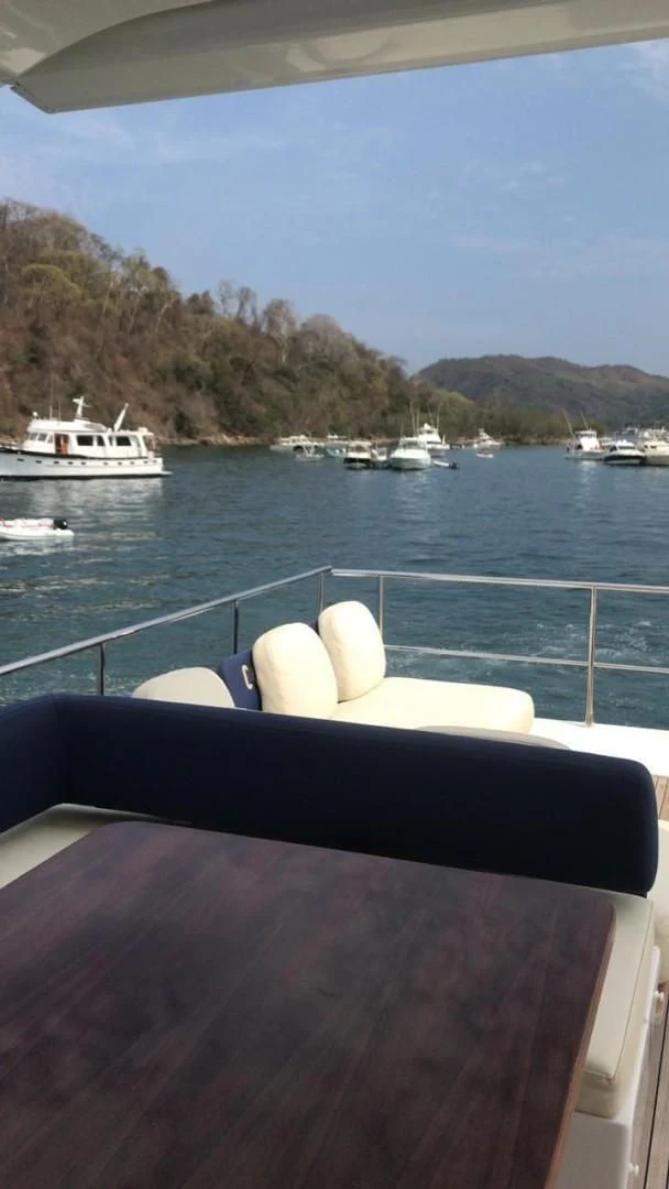 a person's legs on a boat in the water aboard PRIVE Yacht for Sale