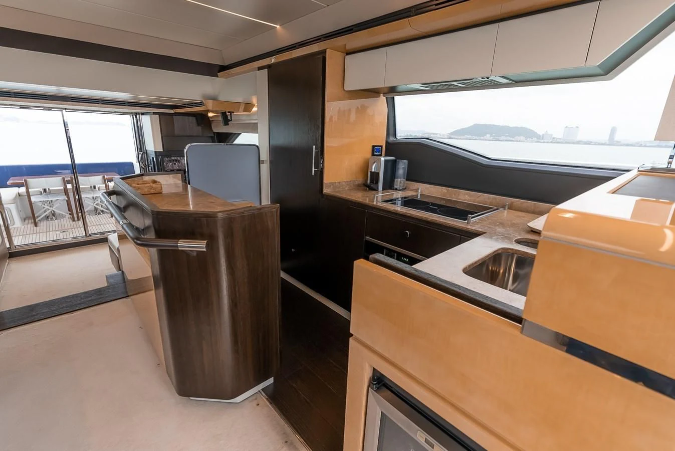 a kitchen with a table and chairs aboard PRIVE Yacht for Sale