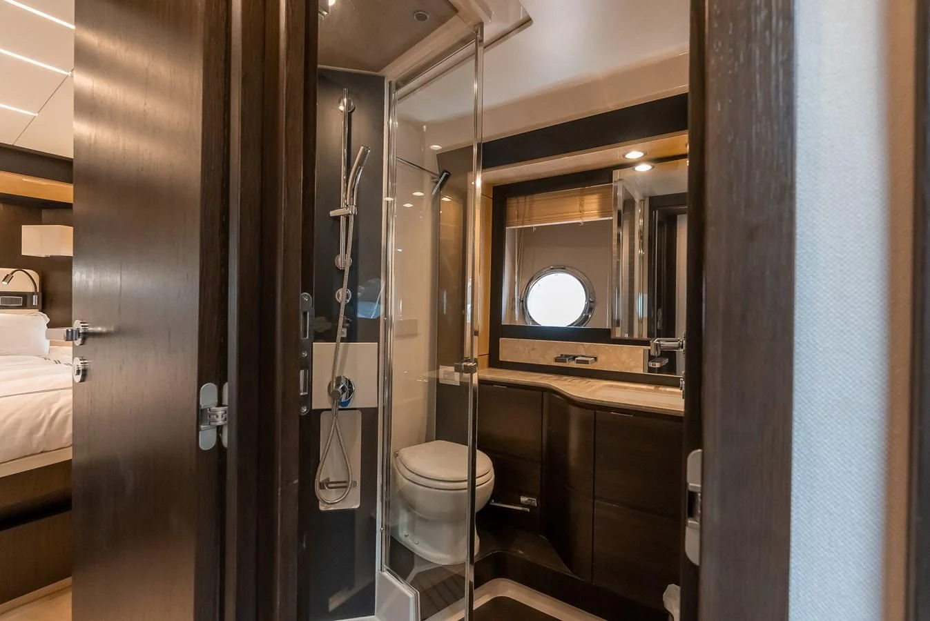 a bathroom with a toilet and a mirror aboard PRIVE Yacht for Sale