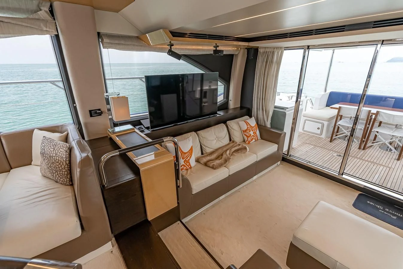 a living room with a large window aboard PRIVE Yacht for Sale