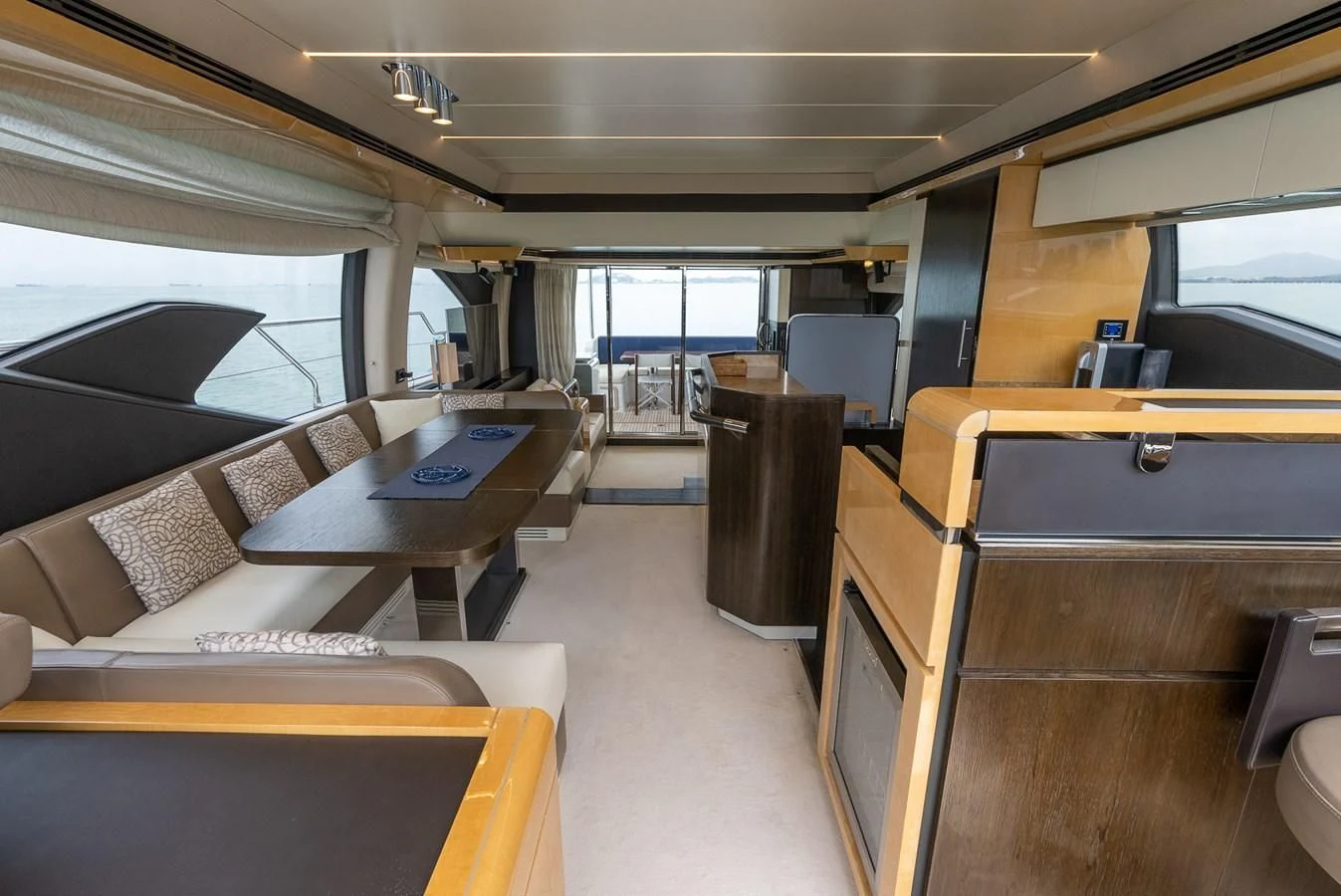 a room with a couch and a table aboard PRIVE Yacht for Sale
