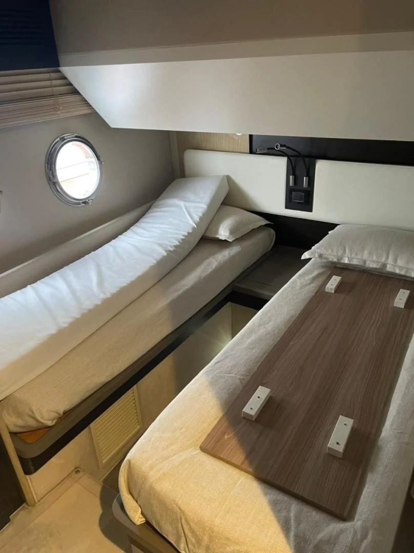a bed with a black headboard aboard PRIVE Yacht for Sale