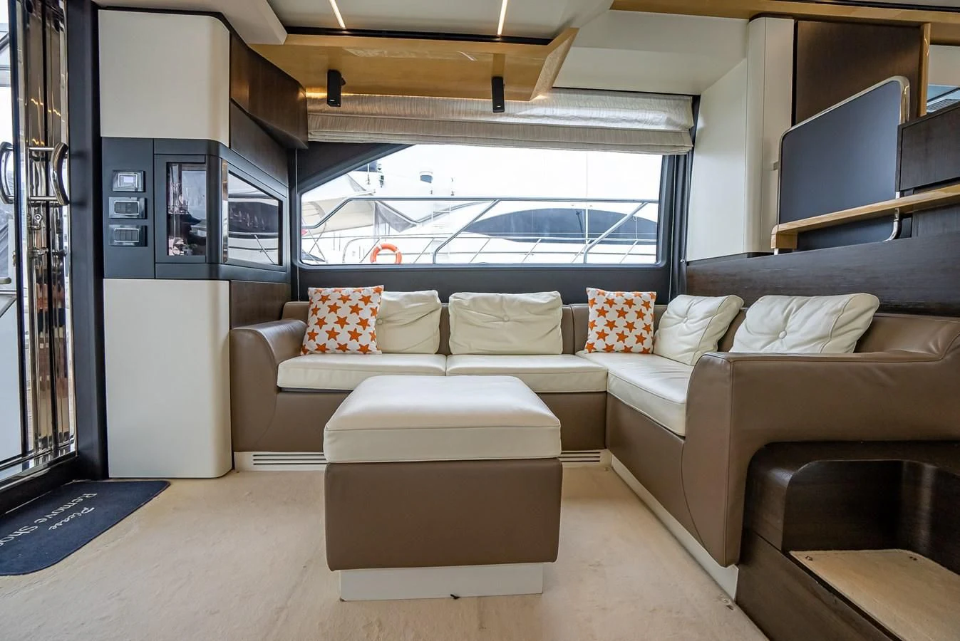 a living room with a couch and a window aboard PRIVE Yacht for Sale