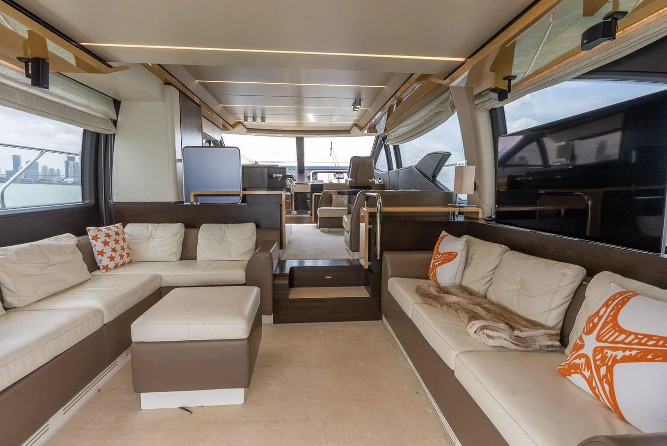 a room with a couch and a table aboard PRIVE Yacht for Sale