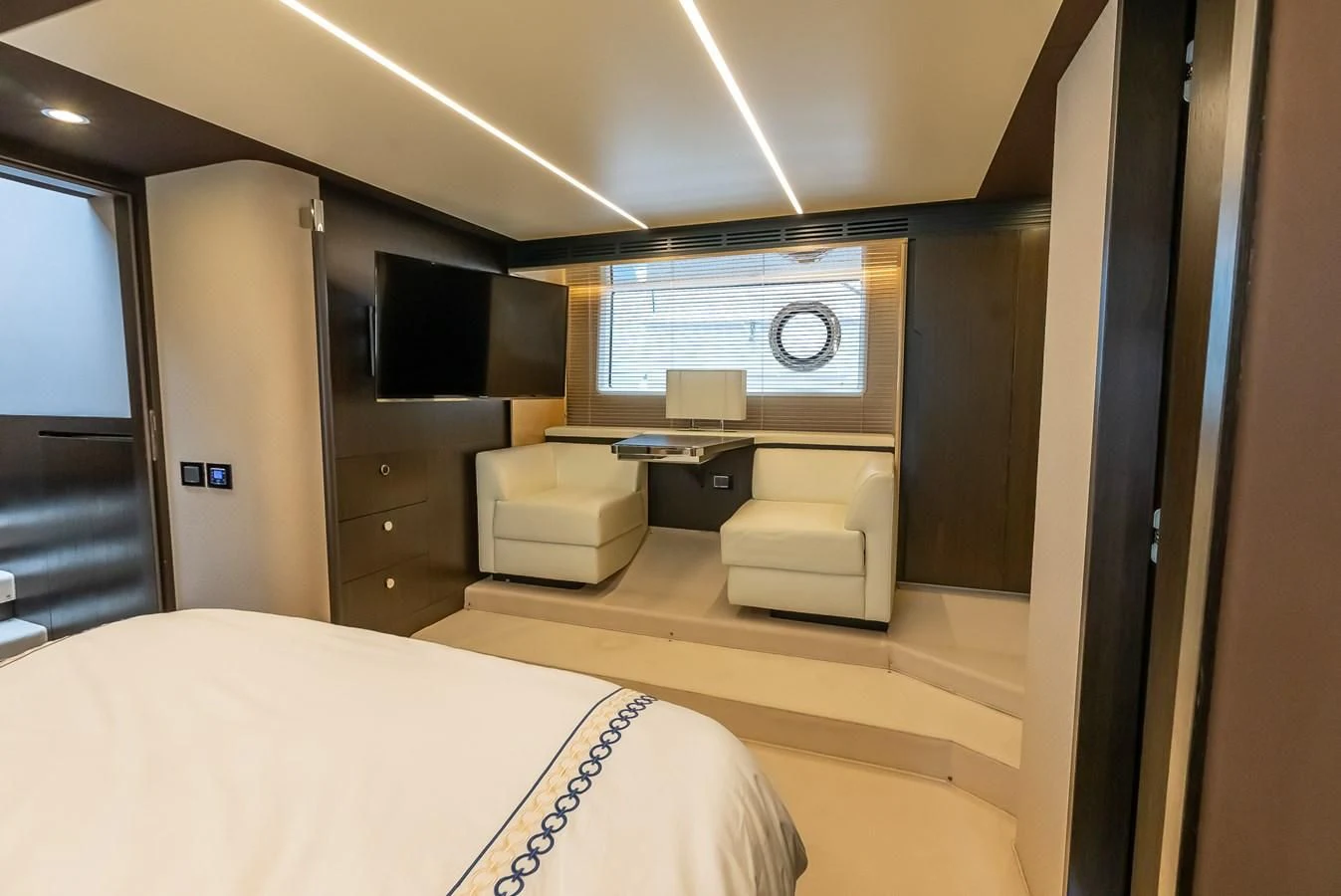 a room with a bed and a desk aboard PRIVE Yacht for Sale