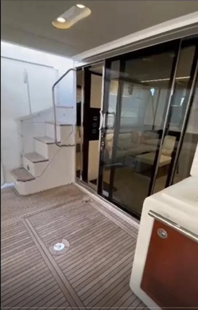 a room with a glass door and a mirror aboard PRIVE Yacht for Sale