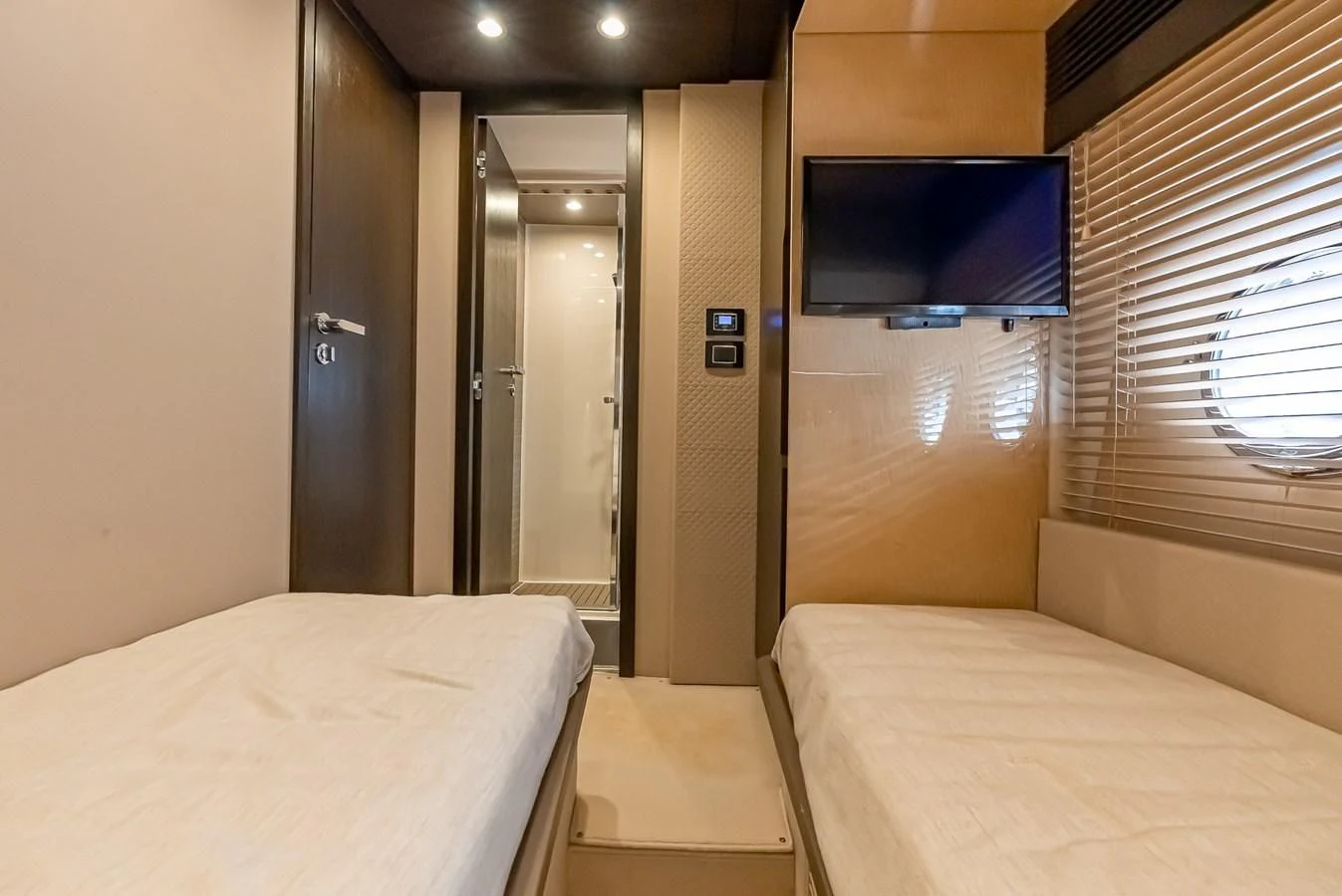 a room with a bed and a television aboard PRIVE Yacht for Sale
