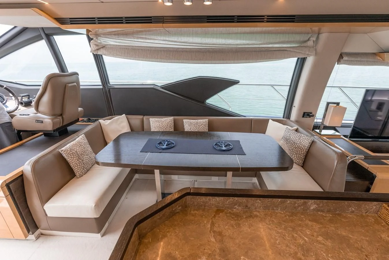 a room with a couch and a table aboard PRIVE Yacht for Sale