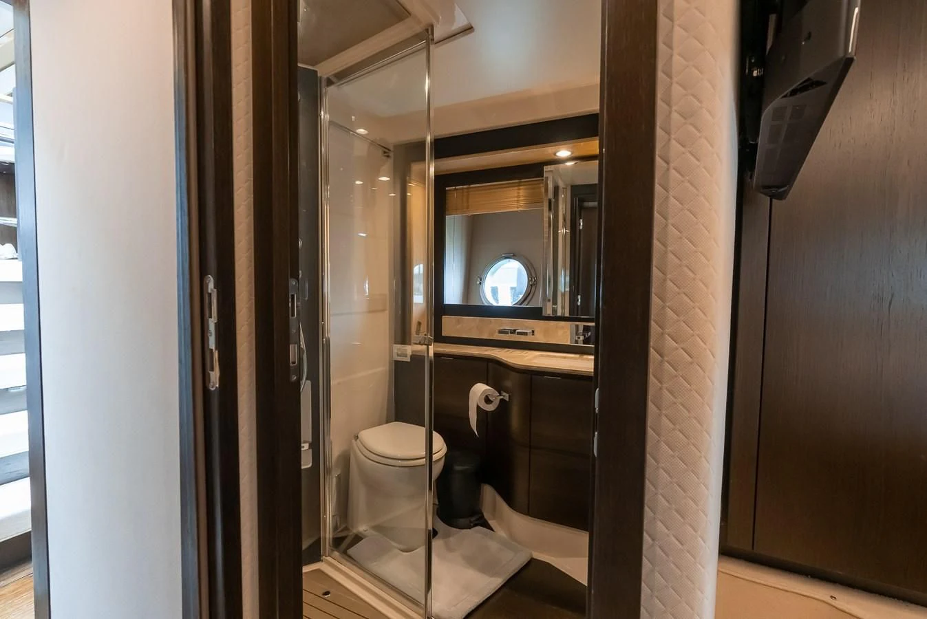 a bathroom with a toilet and a mirror aboard PRIVE Yacht for Sale