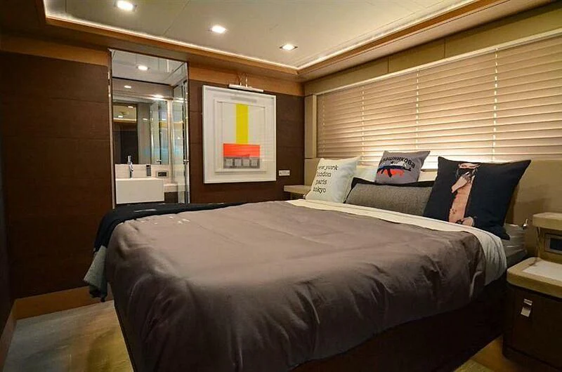 a bedroom with a bed and a mirror aboard SE7EN Yacht for Sale