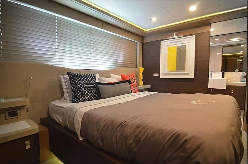 a bed with a black and white bed spread aboard SE7EN Yacht for Sale