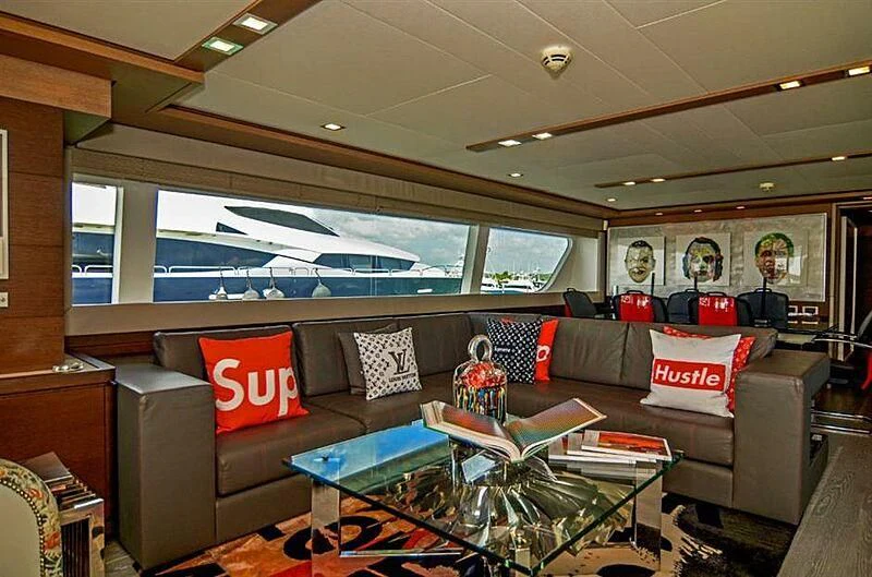 a living room with a large window aboard SE7EN Yacht for Sale