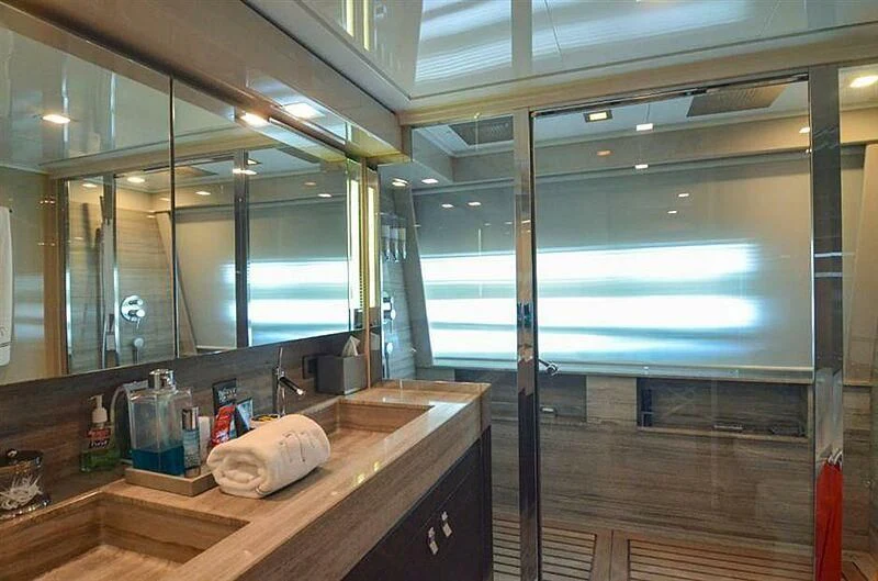 a bathroom with a countertop sink and a large mirror aboard SE7EN Yacht for Sale