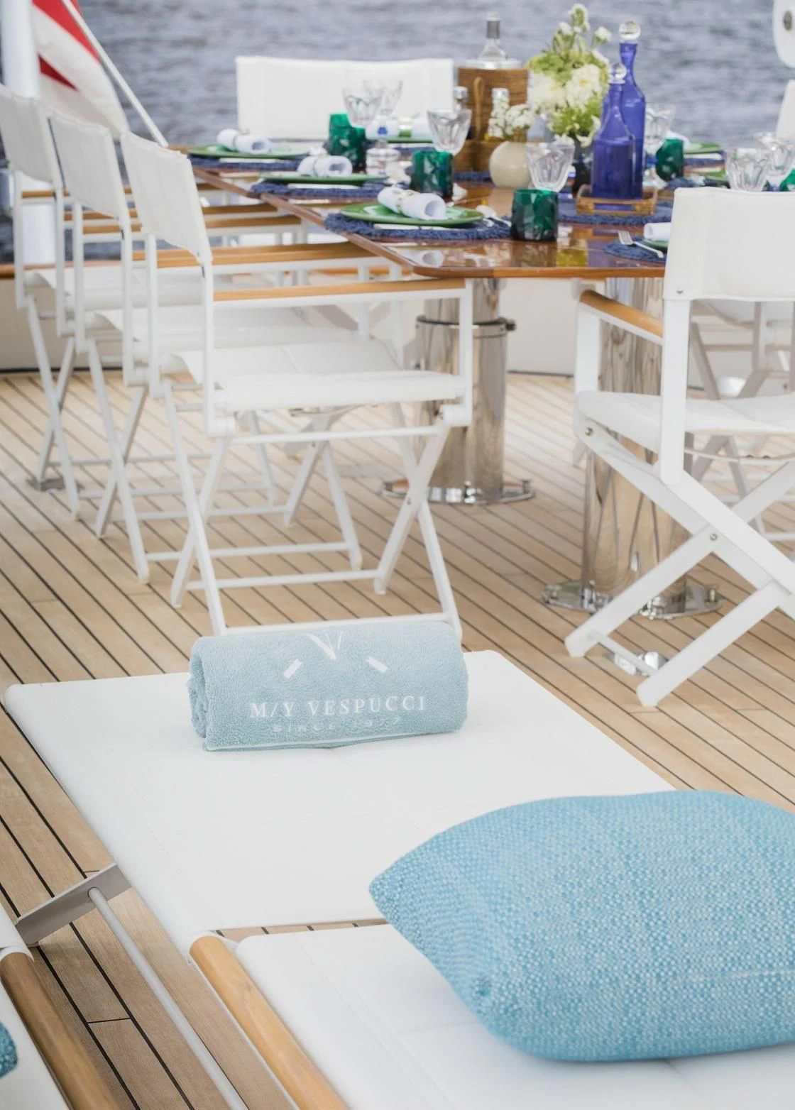 a table with chairs and a blue towel on it aboard VESPUCCI Yacht for Sale
