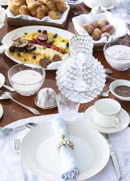 a table with plates and bowls of food on it aboard VESPUCCI Yacht for Sale