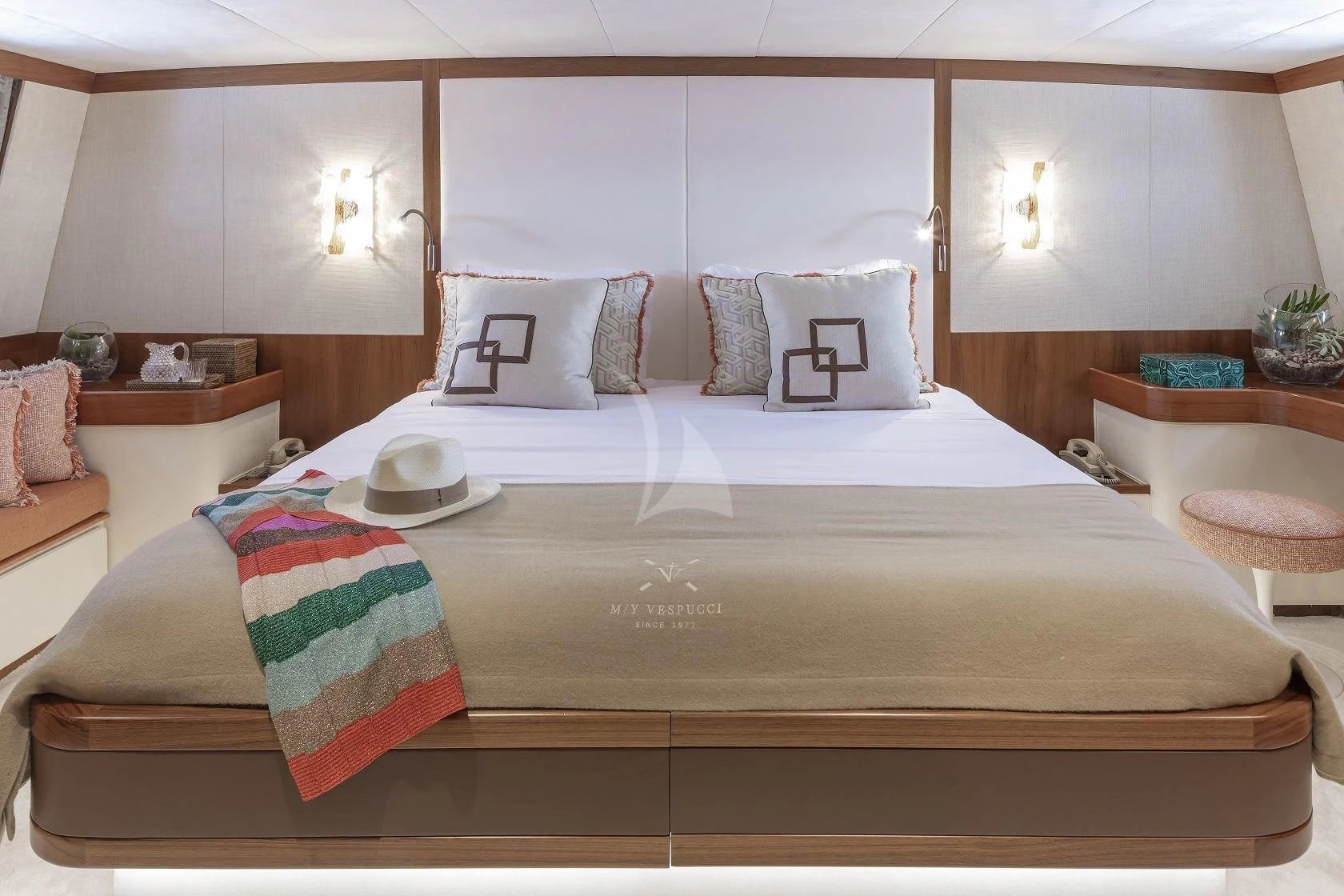 a bed with a white bed spread aboard VESPUCCI Yacht for Sale