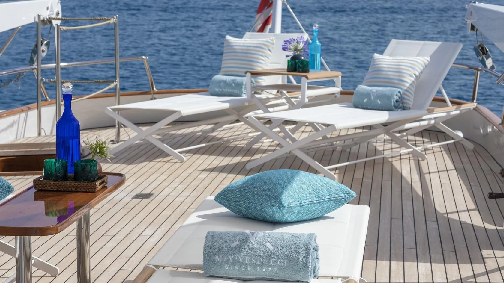 a deck with chairs and pillows on it aboard VESPUCCI Yacht for Sale
