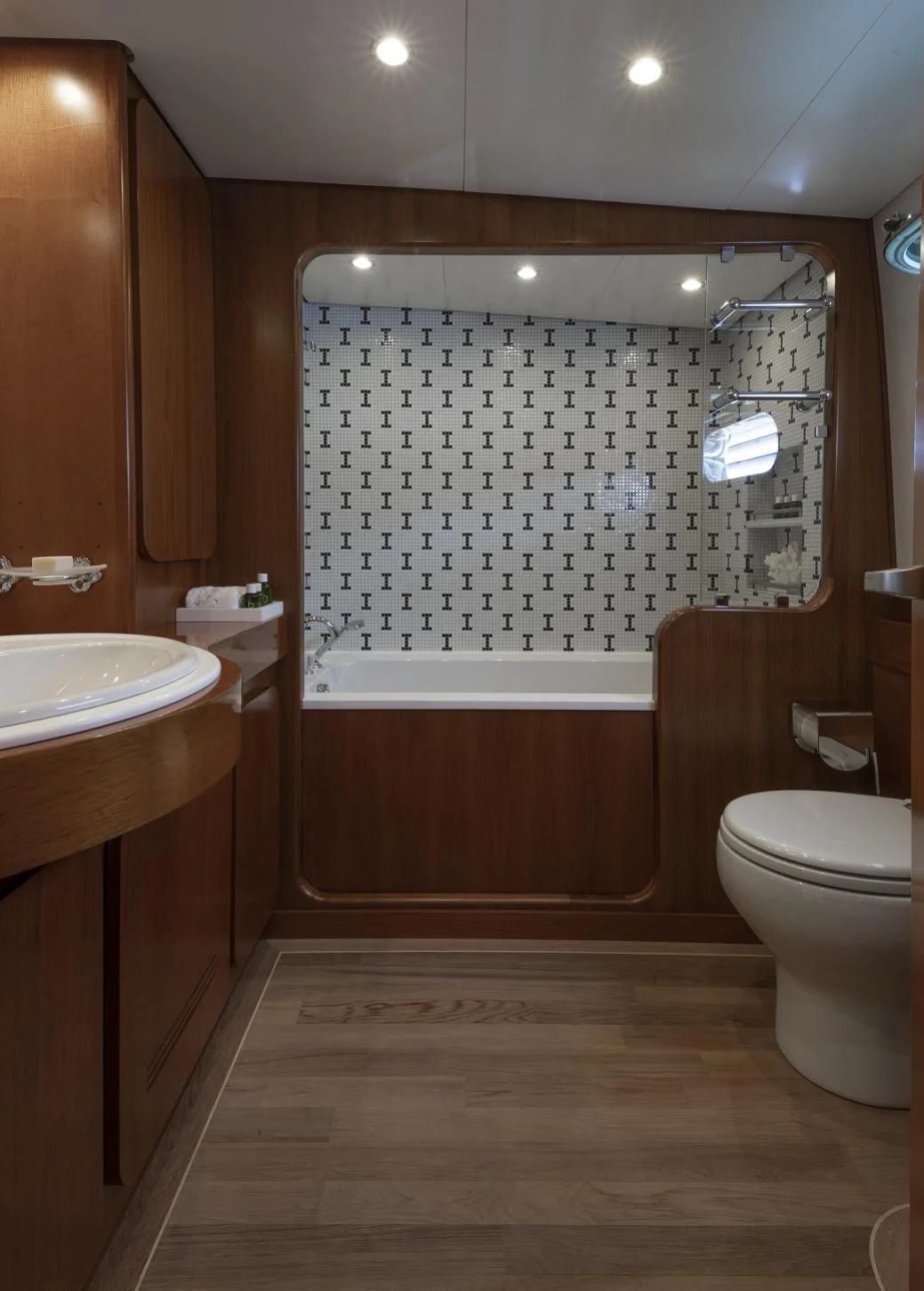 a bathroom with a tub sink and toilet aboard VESPUCCI Yacht for Sale