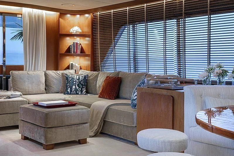 a living room with a couch and a table aboard VESPUCCI Yacht for Sale