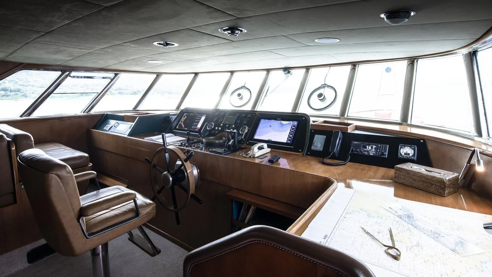 a room with computers and chairs aboard VESPUCCI Yacht for Sale