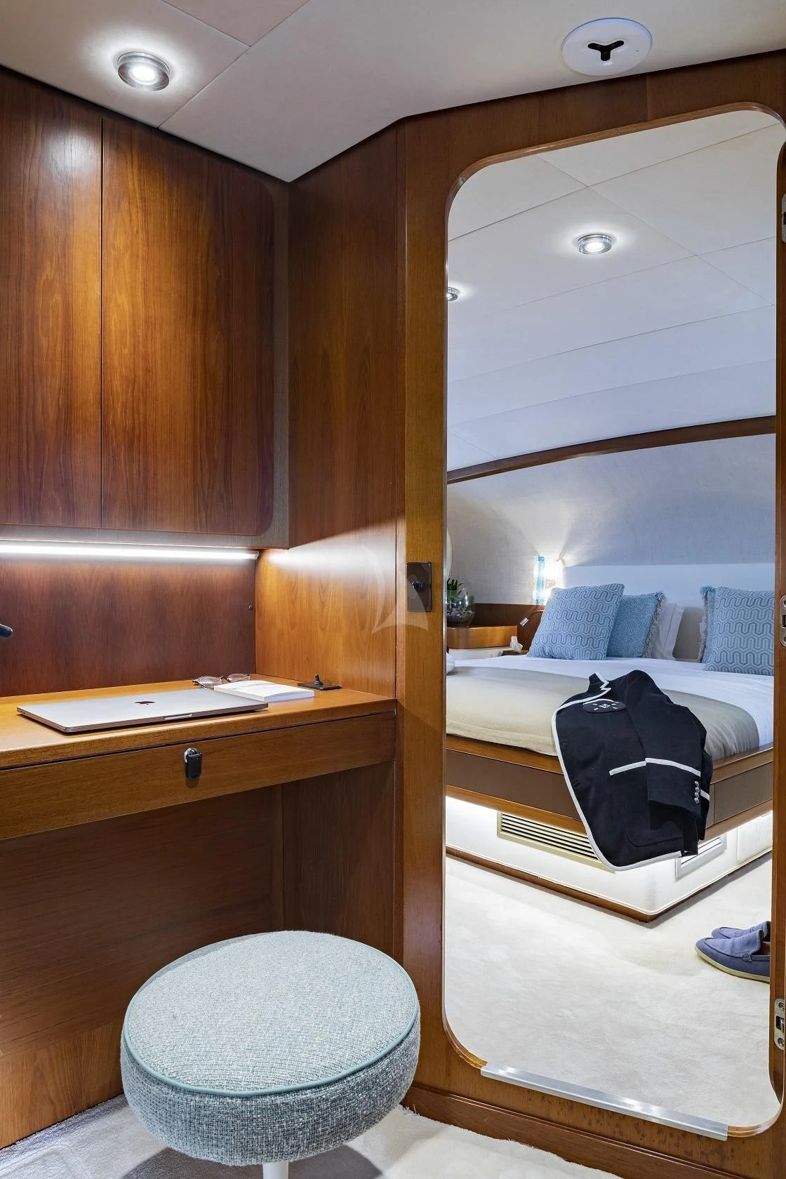 a room with a bed and a mirror aboard VESPUCCI Yacht for Sale