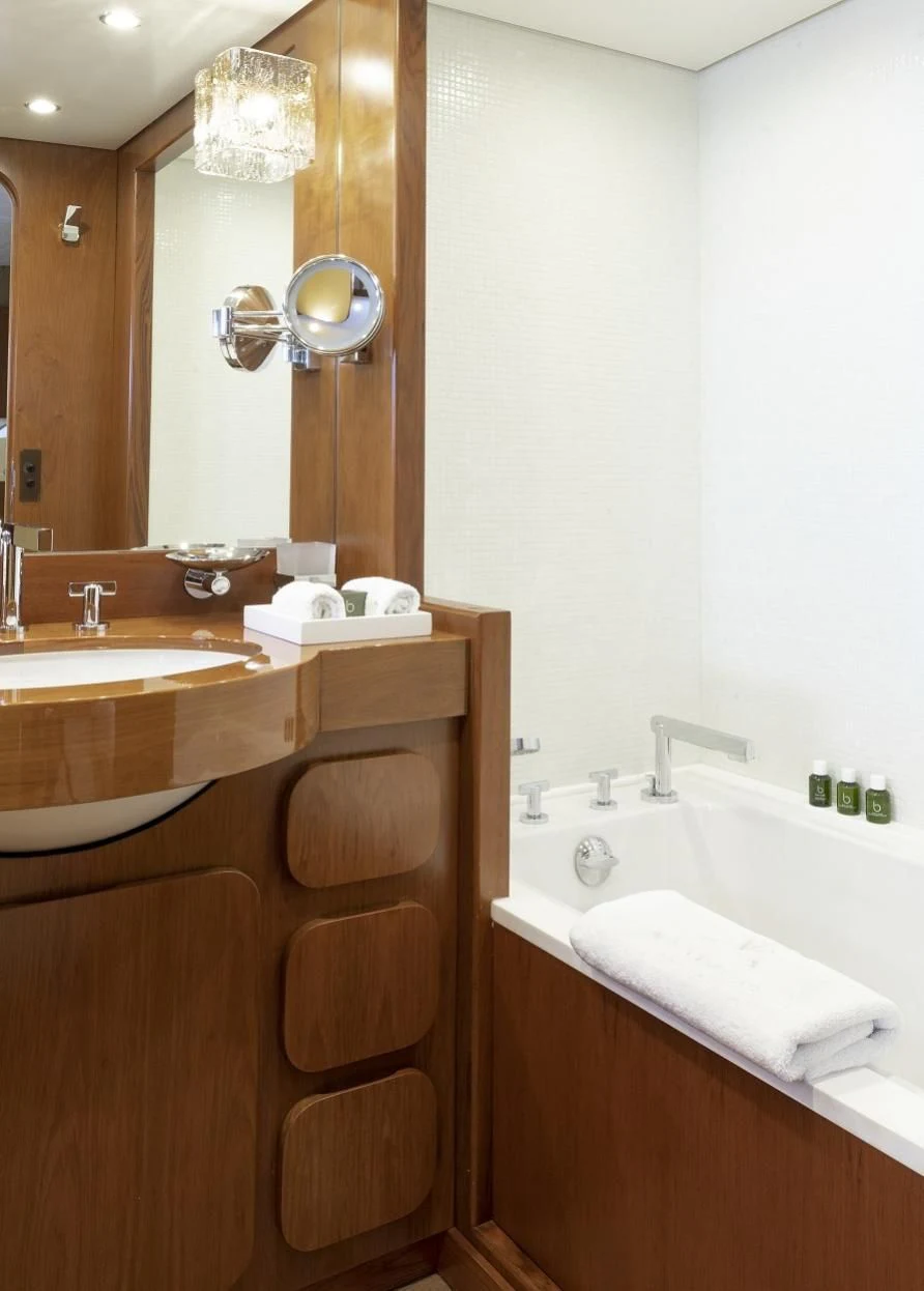 a bathroom with a sink and a bathtub aboard VESPUCCI Yacht for Sale
