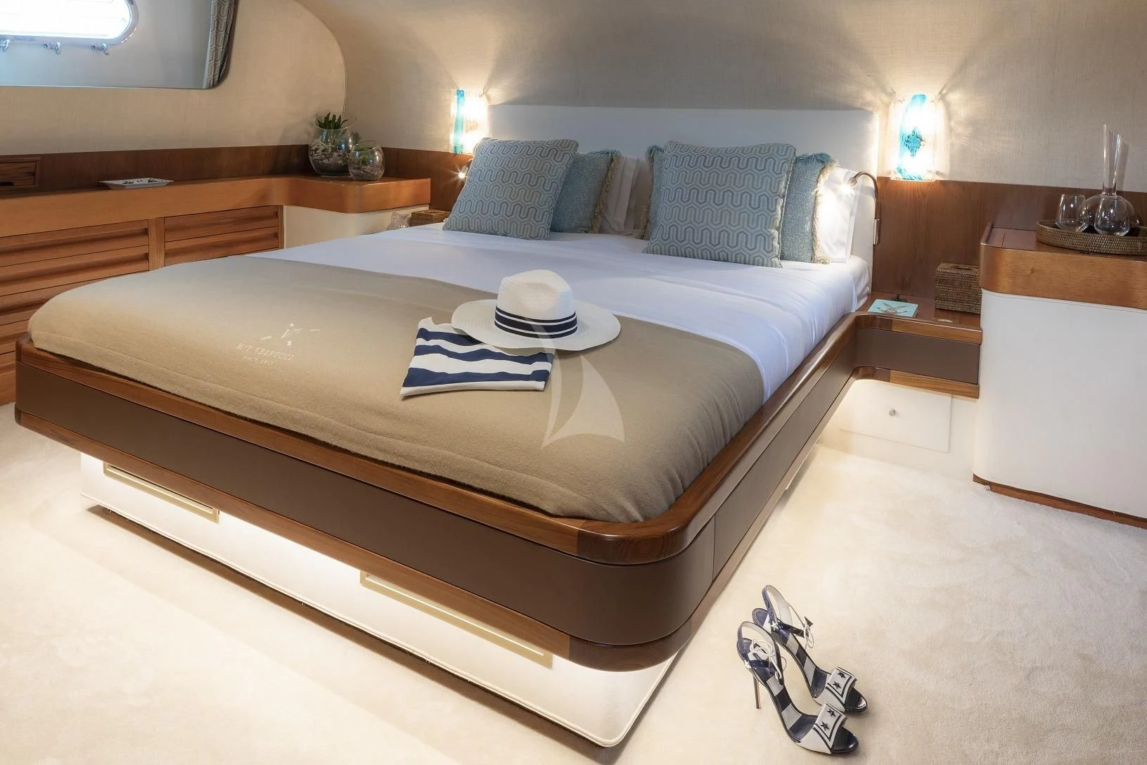 a bed with a blue and white bed spread aboard VESPUCCI Yacht for Sale
