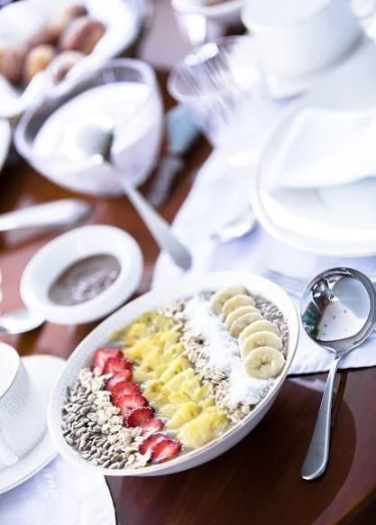 a bowl of food with spoons and a plate of food aboard VESPUCCI Yacht for Sale